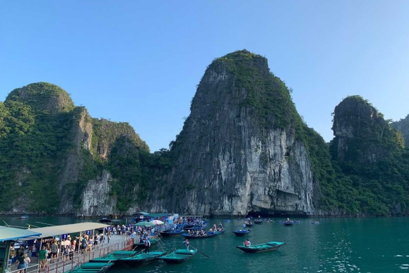 Bamboo Boat Ride Luon Cave Halong Bay pier and boats Crowds of tourists boarding bamboo boats at the floating pier near Luon Cave’s limestone cliffs in Halong Bay