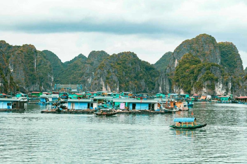 Bamboo Boat Ride Vung Vieng Fishing Village panoramic village view Panoramic view of the floating village at Bamboo Boat Ride Vung Vieng Fishing Village, surrounded by emerald waters and cliffs.