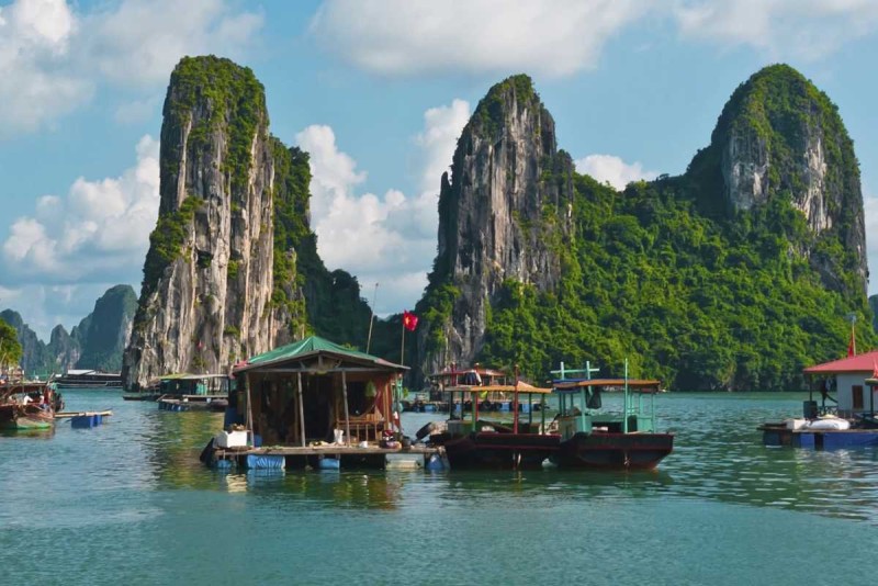 Cua Van Floating Village Halong Bay scenic limestone karsts view Scenic limestone karsts towering over calm waters at Cua Van Floating Village in Halong Bay, a UNESCO World Heritage site