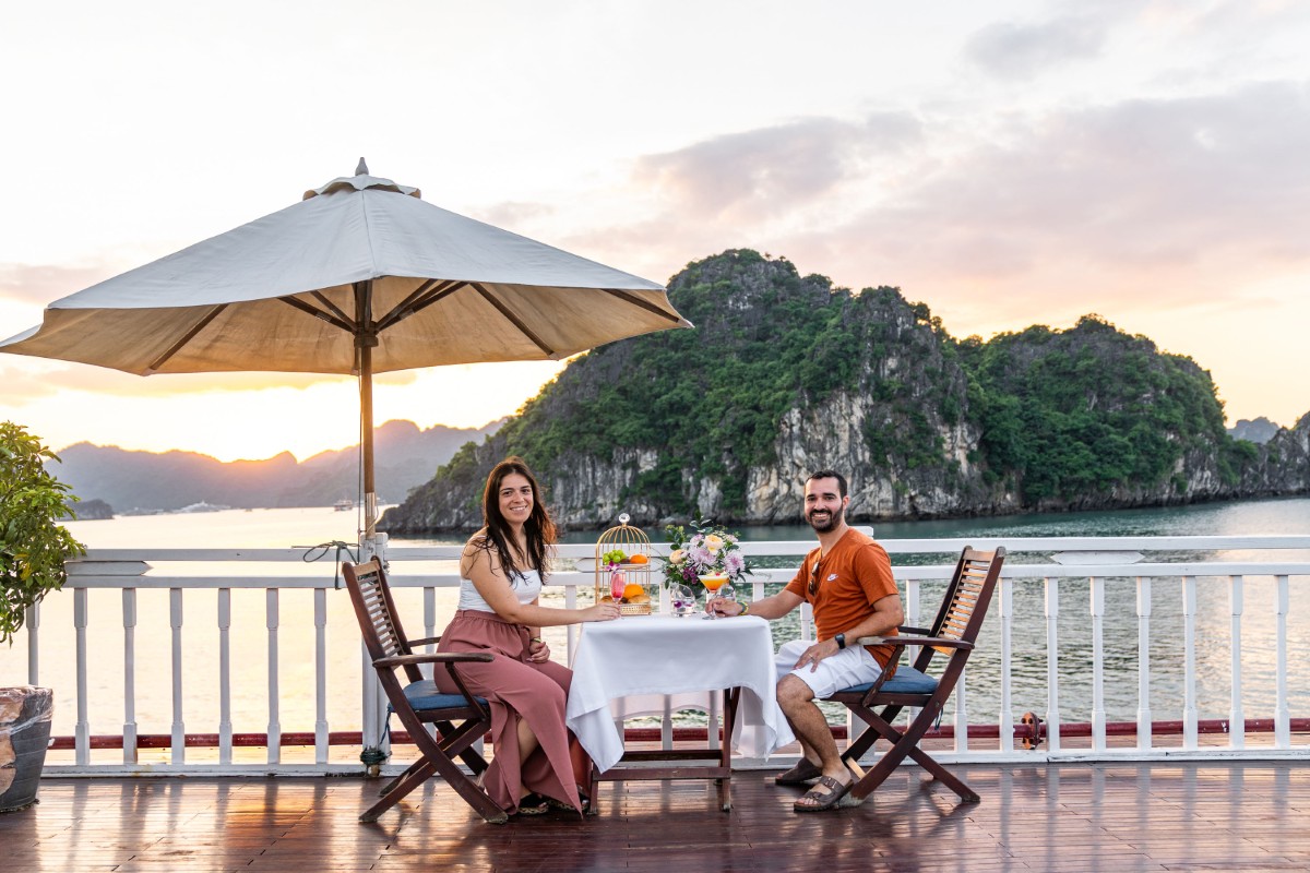 Luxurious sundeck on a cruise with refreshing cocktails and scenic views of Halong Bay