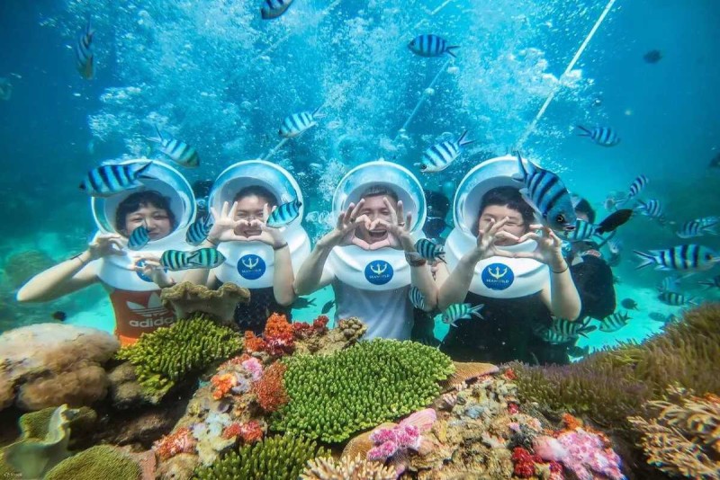 Snorkeling at Hon Mot Island Nha Trang Snorkelers floating on crystal-clear waters above coral reefs at Hon Mot Island