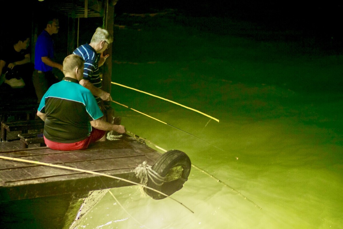 A group enjoying squid fishing at night on Halong Bay cruises