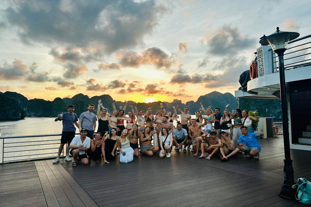 A lively sunset party on a Halong Bay cruise deck