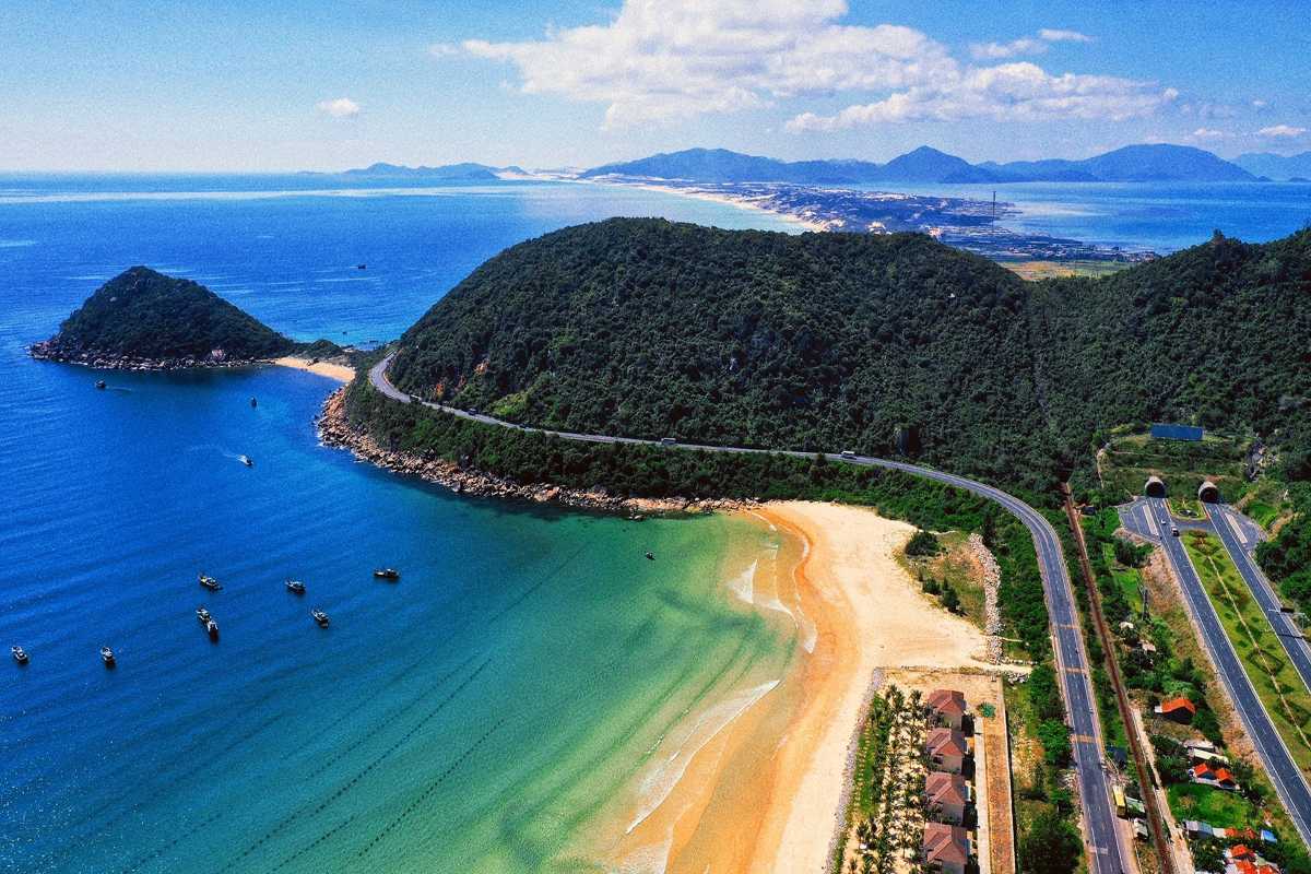 Aerial view of Dai Lanh Beach and coastal road Aerial perspective of Dai Lanh Beach with sandy shore, coastal road, and green hills in Nha Trang