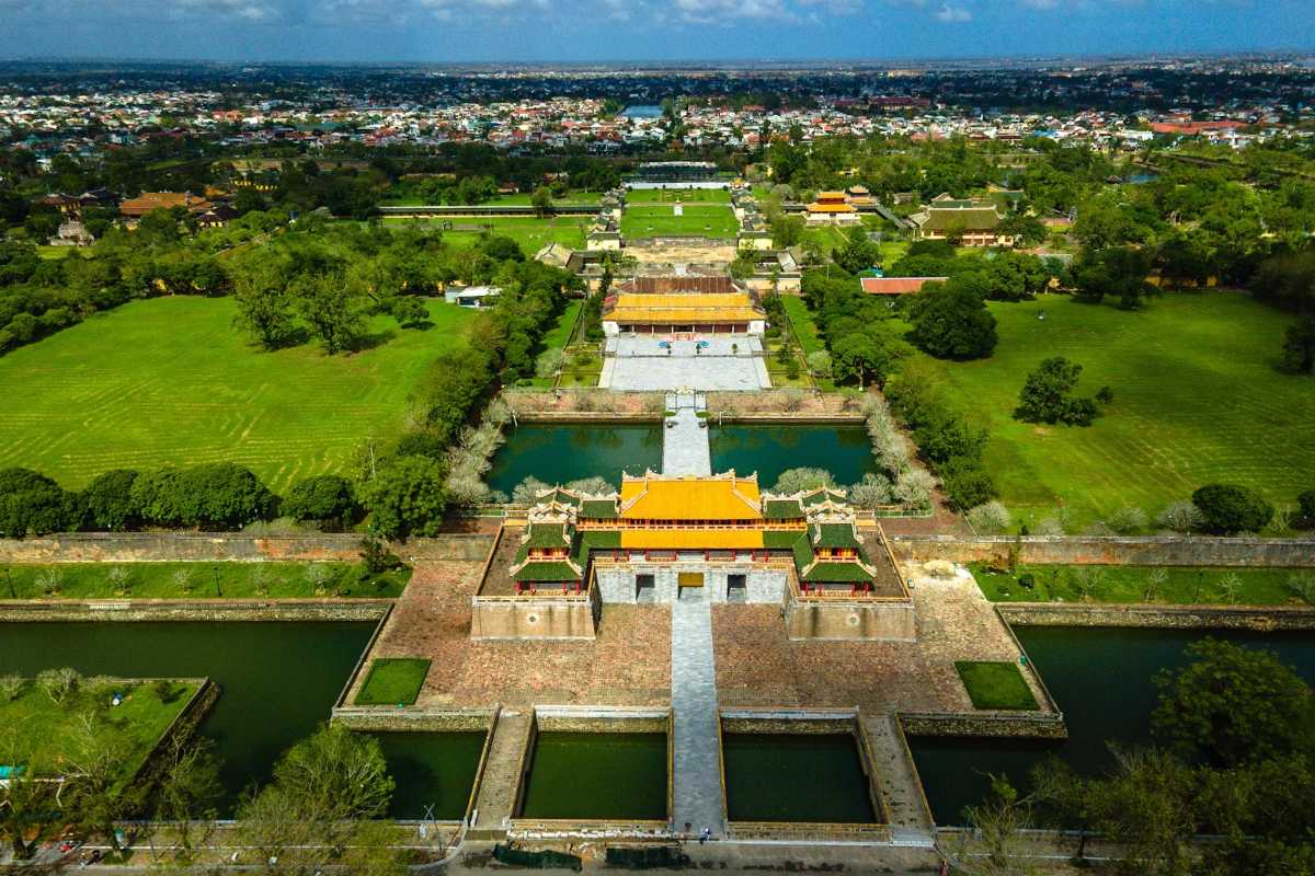 Aerial View of Hue Imperial City and Perfume River Aerial view of Hue Imperial City with the Perfume River flowing nearby, surrounded by lush greenery and urban areas.