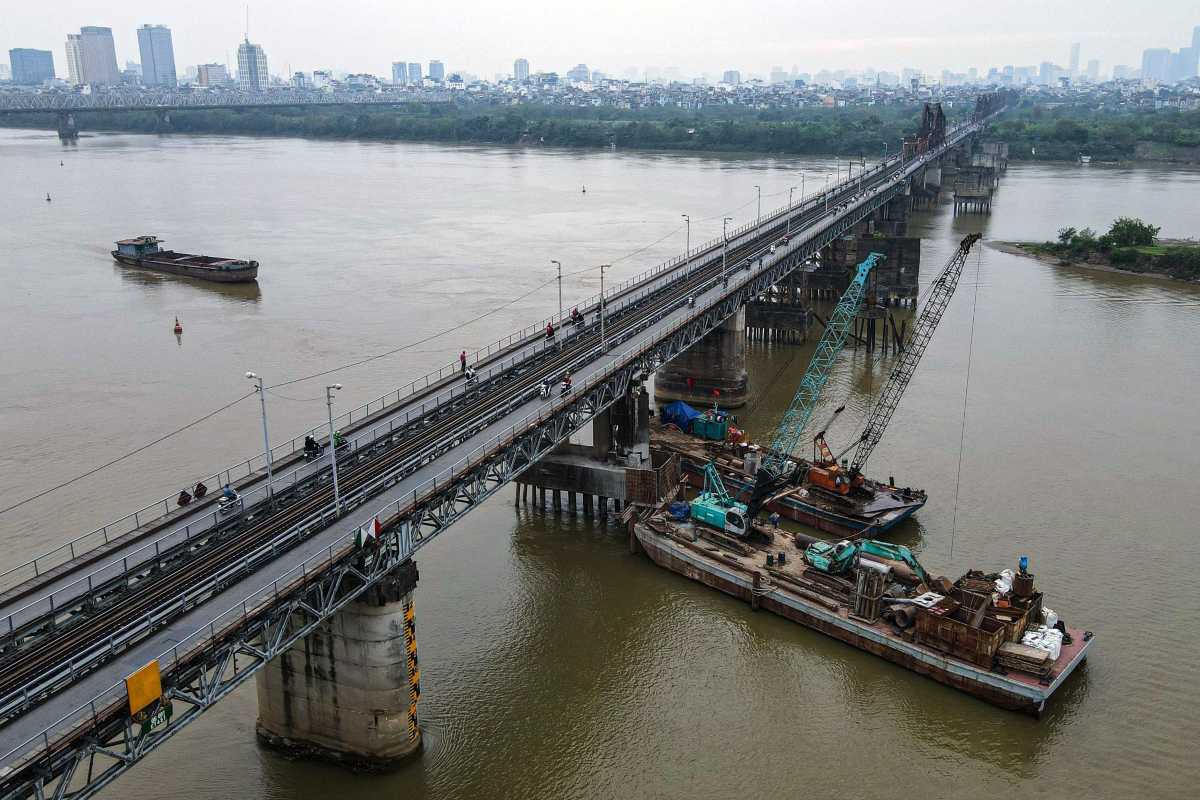 Aerial View of Long Bien Bridge and Hanoi Skyline Aerial photo showing Long Bien Bridge connecting Hanoi's urban skyline with the river below