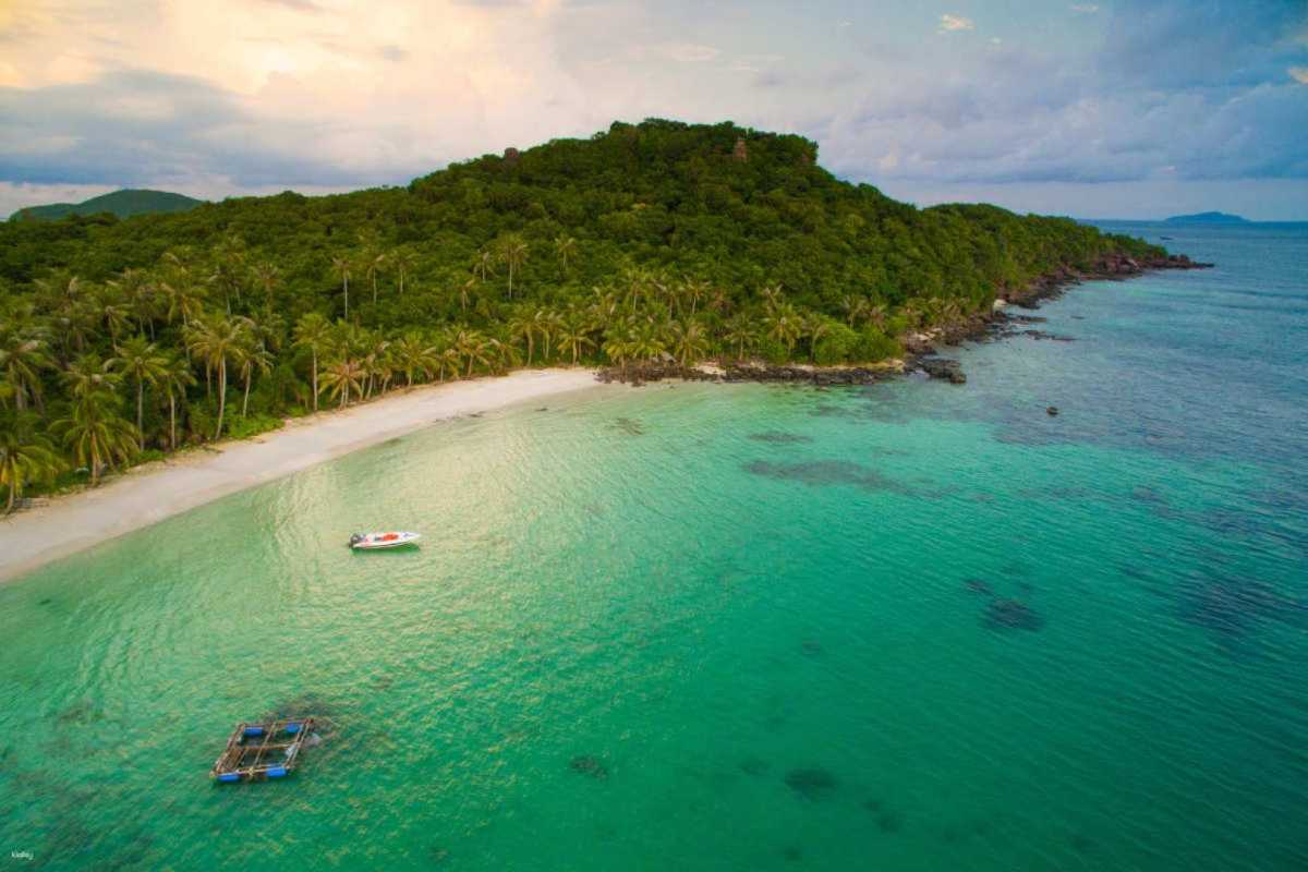 Aerial View of May Rut Trong Island Coastline Aerial view of May Rut Trong Island’s coastline showing lush green forest and clear sea waters
