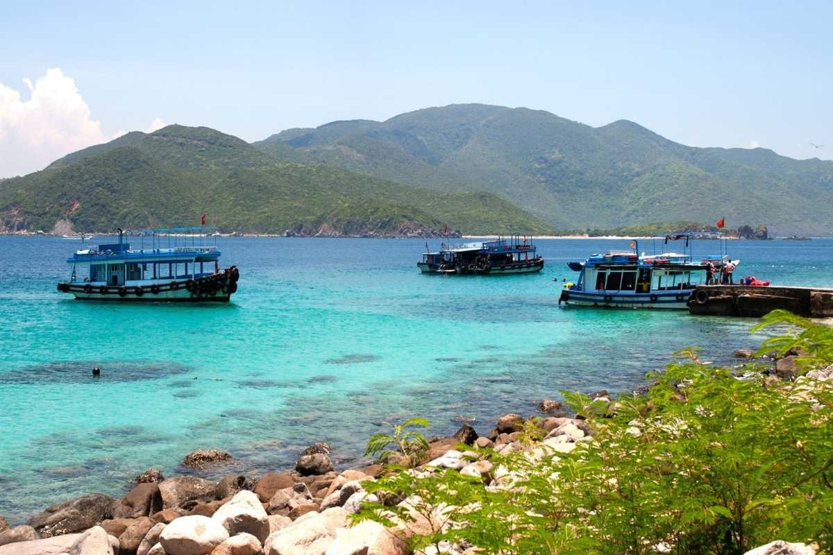Aerial view of Nha Trang Bay island and boats Aerial photo showing boats docked near islands in Nha Trang Bay with turquoise water