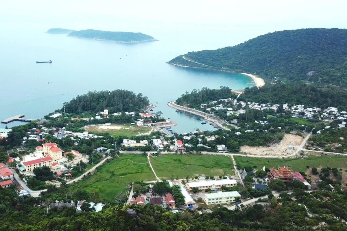 Aerial view of Cham Islands, showcasing the village, coastline, and lush green surroundings.