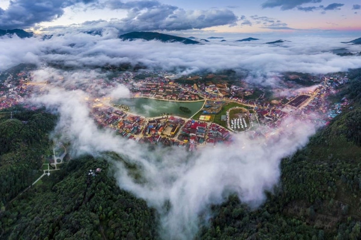 Aerial view of Sapa town enveloped in clouds, seen from Ham Rong Mountain.