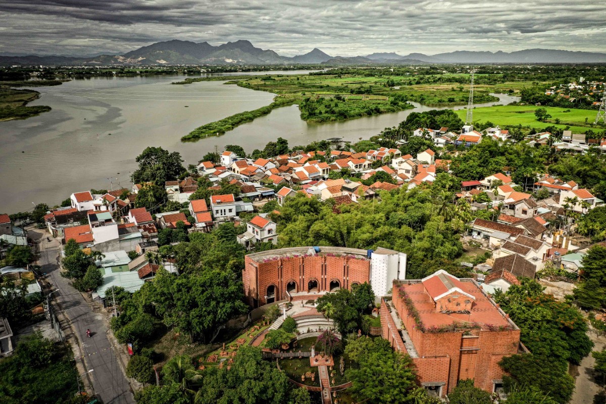 Aerial view of Thanh Ha Pottery Village showcasing traditional Vietnamese houses along the riverside in Hoi An.