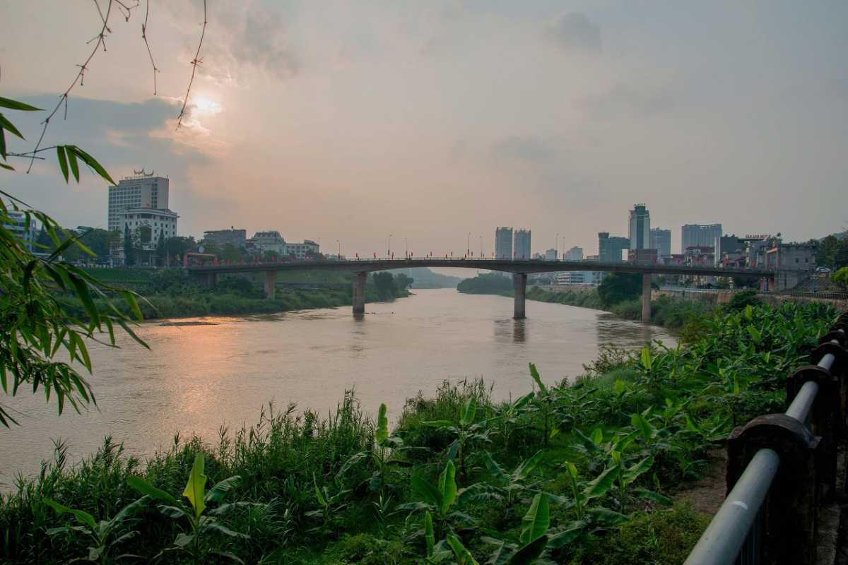 Aerial View of the Red River Vietnam and Surrounding Area Aerial photo capturing the Red River Vietnam flowing past urban and rural landscapes