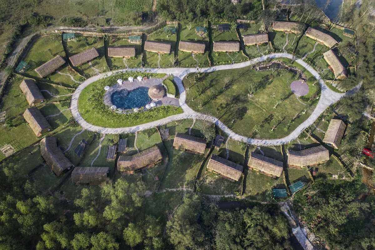 Aerial View of Cottages at Alba Thanh Tan Bird's-eye view of rustic cottages arranged around a central pool at Alba Thanh Tan Hot Springs