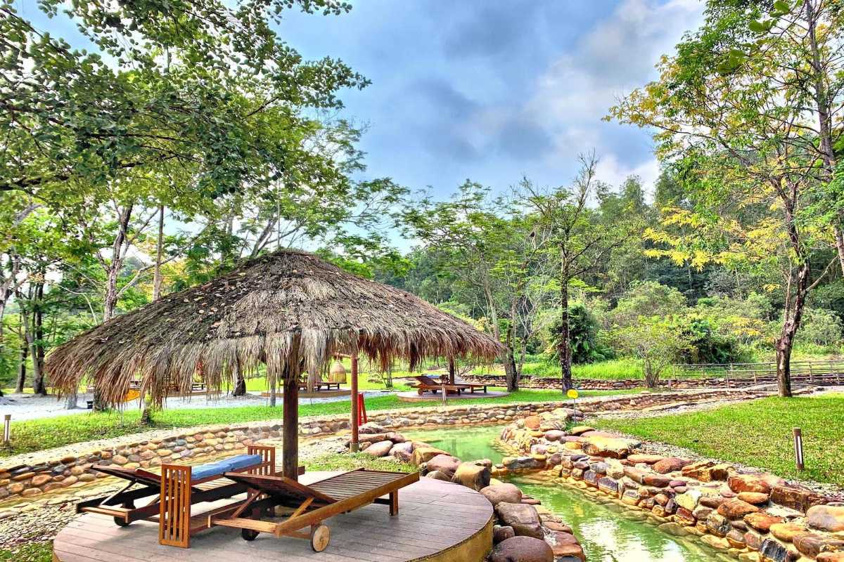 Relaxing Outdoor Gazebo at Alba Thanh Tan Outdoor wooden gazebo with lounge chairs beside natural hot spring pools at Alba Thanh Tan