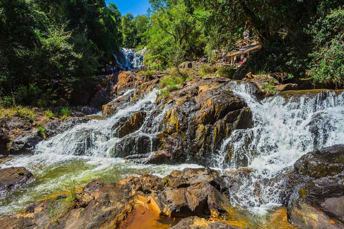 Scenic Alpine Coaster Ride Through Datanla Waterfalls Visitors enjoying alpine coaster ride winding through lush forests near Datanla Waterfalls in Da Lat