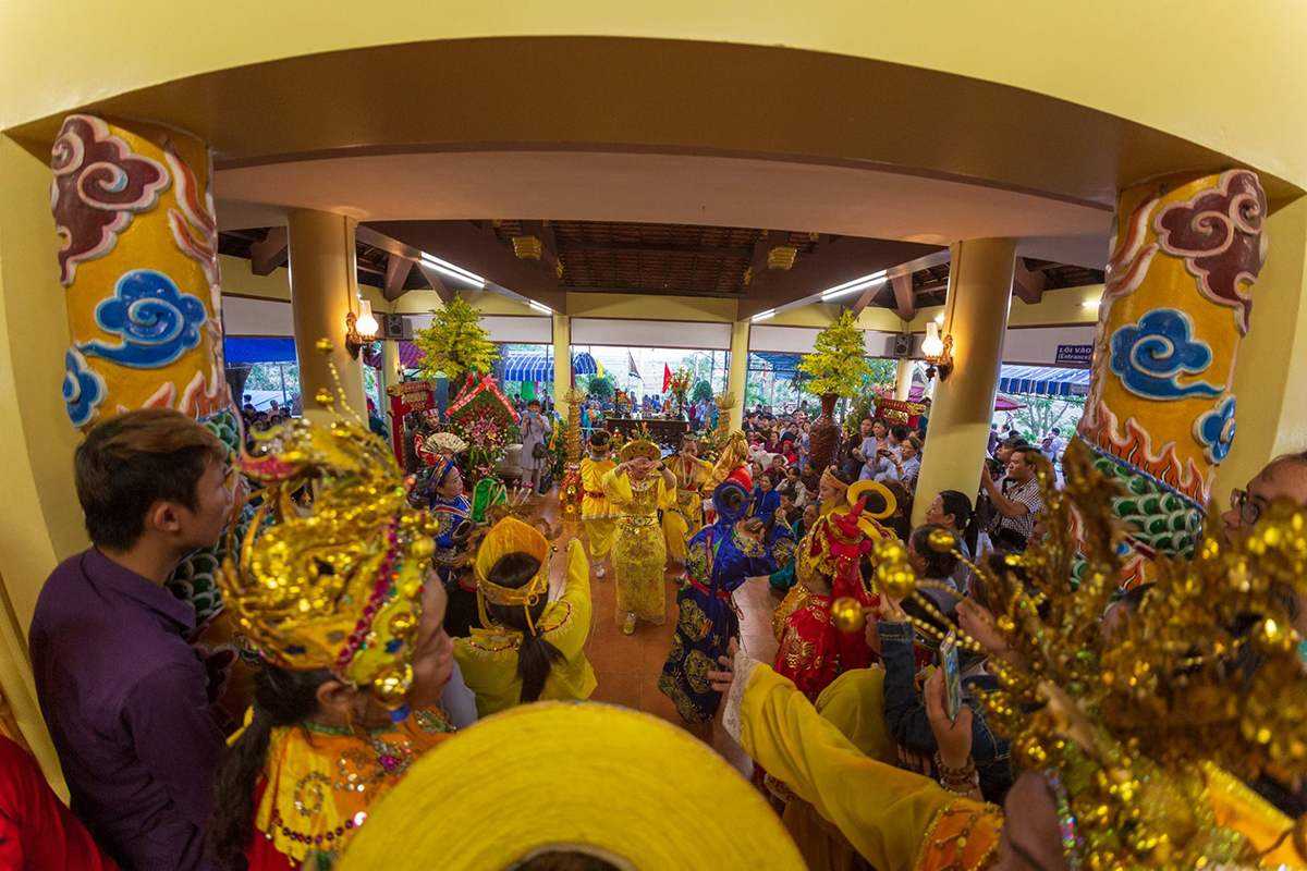 Traditional dancing at Am Chua celebration Worshippers dressed in yellow and blue robes perform sacred dance inside Am Chua Temple hall.