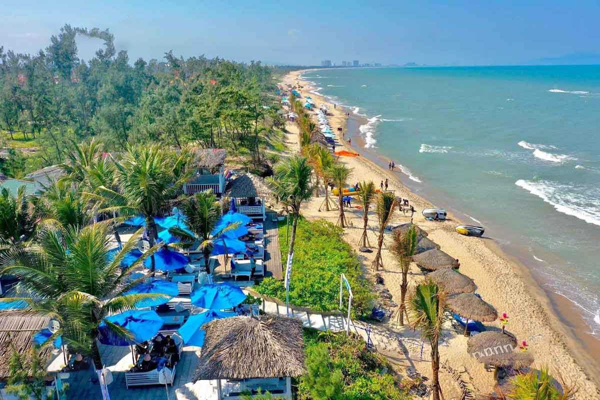 An Bang Beach Hoi An Coastal View Scenic aerial view of An Bang Beach coastline with palm trees, beach umbrellas, and calm waters