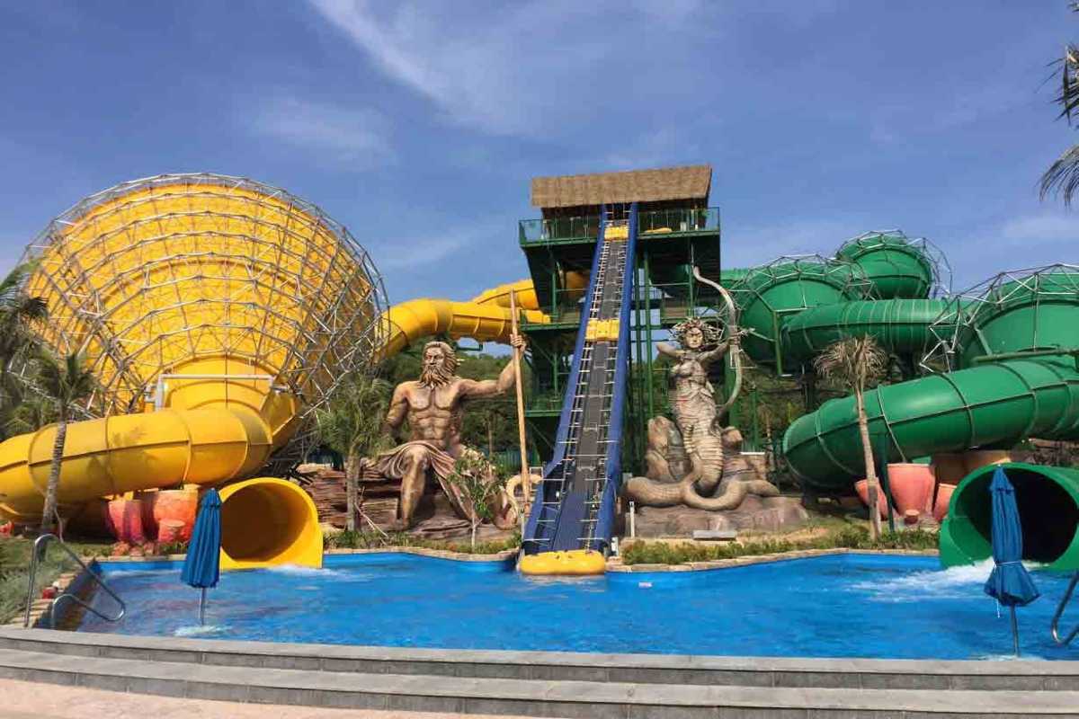 Aquatopia Water Park Water Slides with Tall Trees Colorful water slides towering over palm trees at Aquatopia Water Park, Hon Thom Island