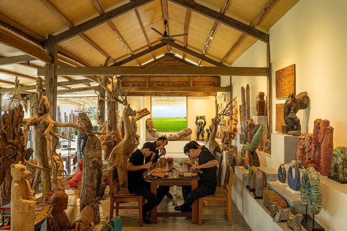 Artisan Workshop Interior at Kim Bong Carpentry Village Artisans carving detailed wooden sculptures inside a workshop at Kim Bong Carpentry Village