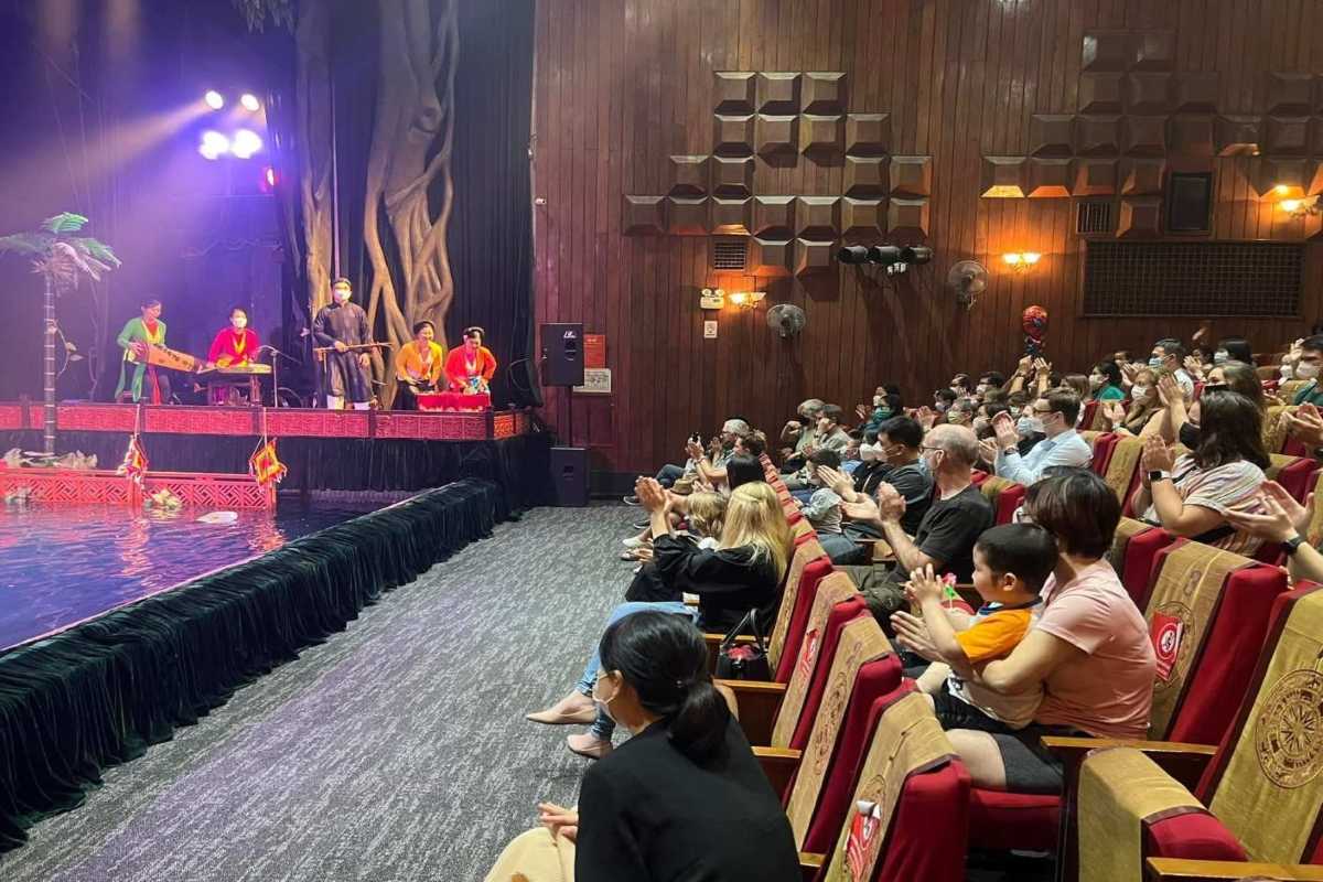 Audience Watching Water Puppet Show Performance Engaged audience seated inside the theatre watching the vibrant Water Puppet Show in Hanoi