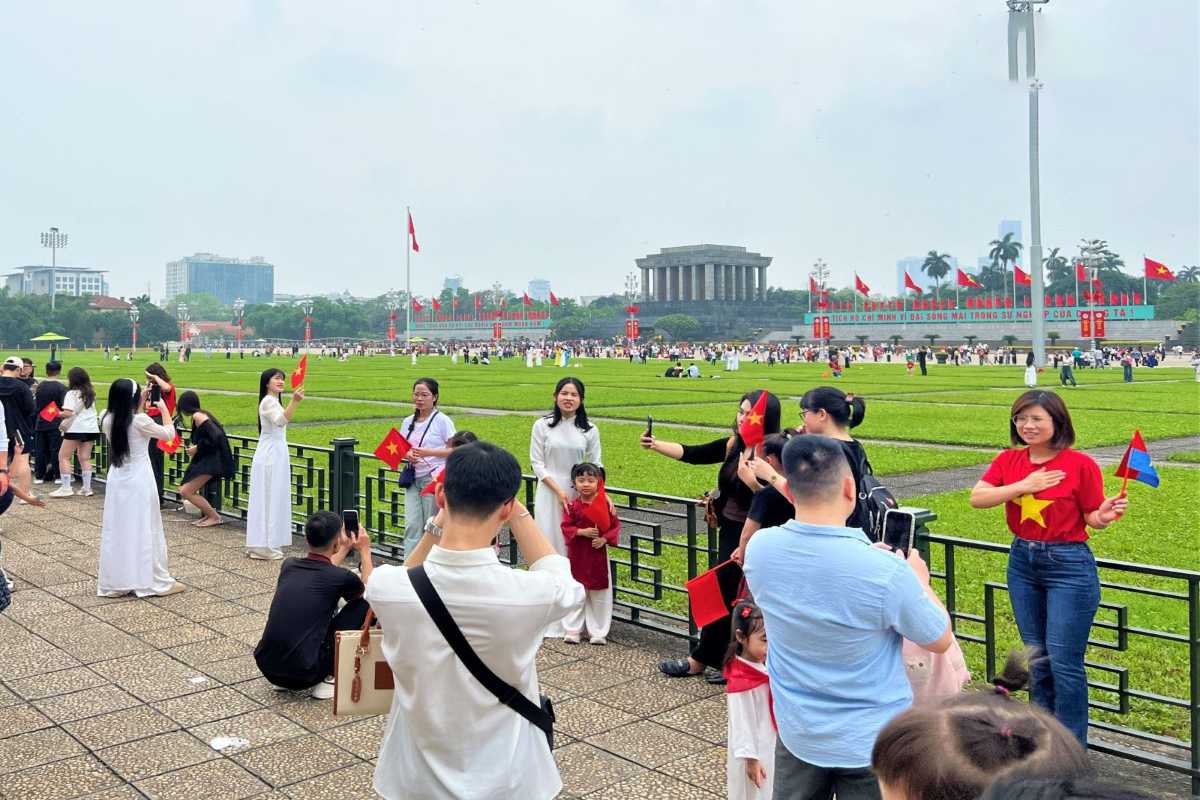 People at Ba Dinh Square Hanoi Enjoying the Ceremony People participating in a ceremony at Ba Dinh Square Hanoi