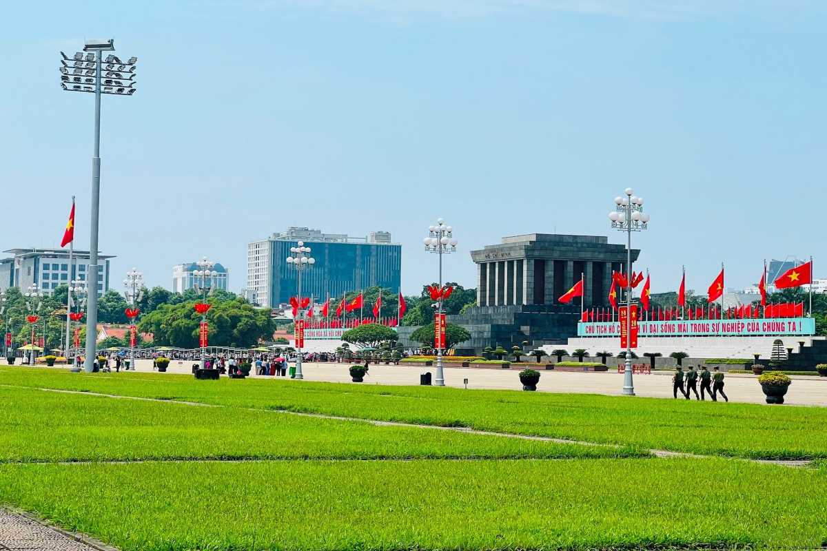 Ba Dinh Square Hanoi - Flag Raising Ceremony Ba Dinh Square Hanoi with Vietnamese flags during the flag raising ceremony in front of the Ho Chi Minh Mausoleum.