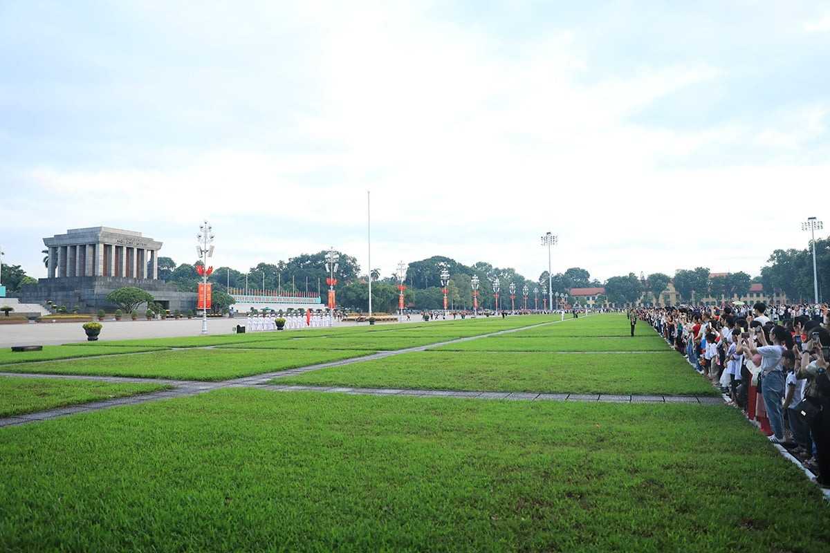 Ba Dinh Square Hanoi - Flag Raising Event in Action Ho Chi Minh Mausoleum with the flag raising ceremony taking place, capturing the dramatic scene at Ba Dinh Square Hanoi.