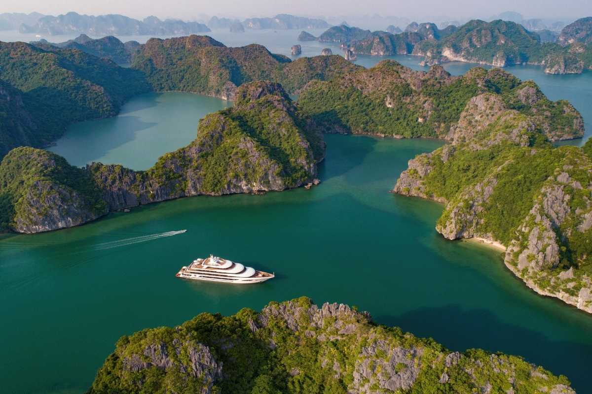 Ba Ham Lake Halong Bay panoramic view with boats Panoramic view of Ba Ham Lake Halong Bay with multiple boats navigating emerald waters among limestone islands.