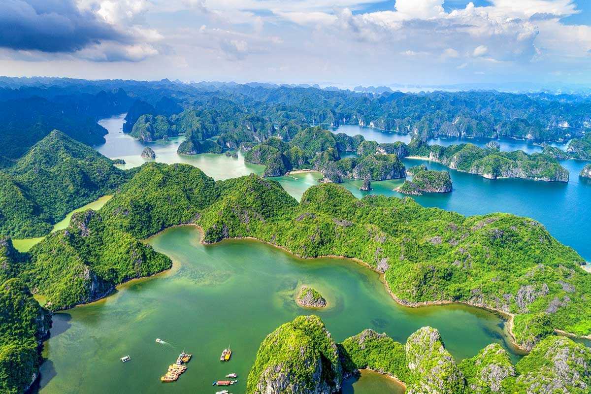 Ba Ham Lake Halong Bay peaceful lake and limestone cliffs Serene lake waters surrounded by steep limestone cliffs at Ba Ham Lake Halong Bay.