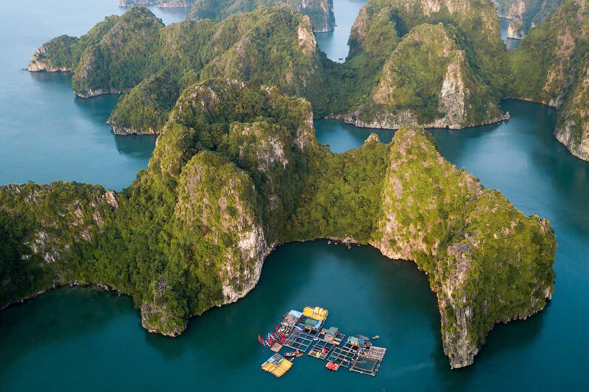 Ba Ham Lake Halong Bay Scenic Limestone Karsts and Floating Village Ba Ham Lake Halong Bay featuring limestone karsts and a floating fishing village nestled in calm freshwater lake