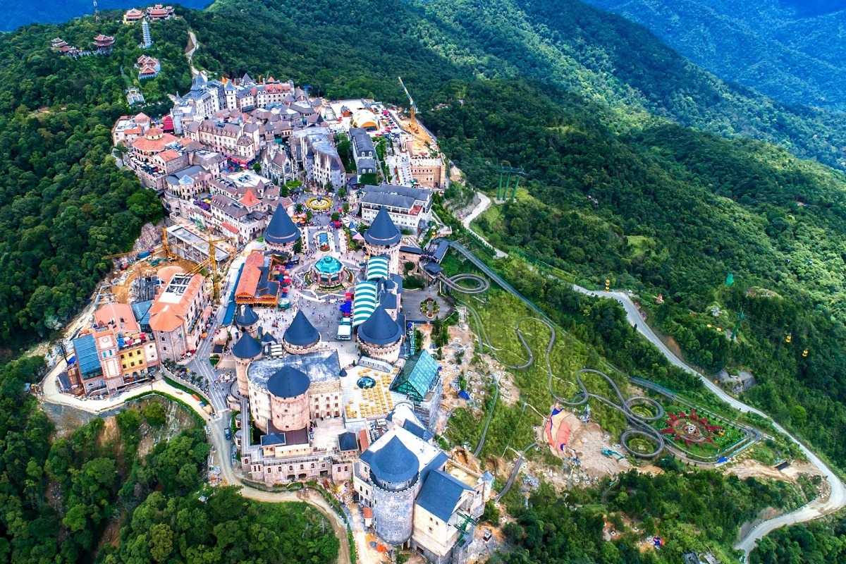 Ba Na Hills French Village aerial medieval architecture overview Aerial view of Ba Na Hills French Village with medieval-style towers, colorful rooftops, and winding streets