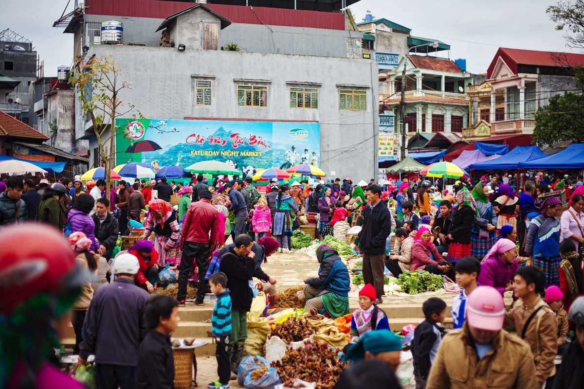 Bac Ha Market Sapa colorful umbrella market and highland produce Bac Ha Market colorful umbrellas shade ethnic vendors selling fresh fruits, vegetables, and local specialties