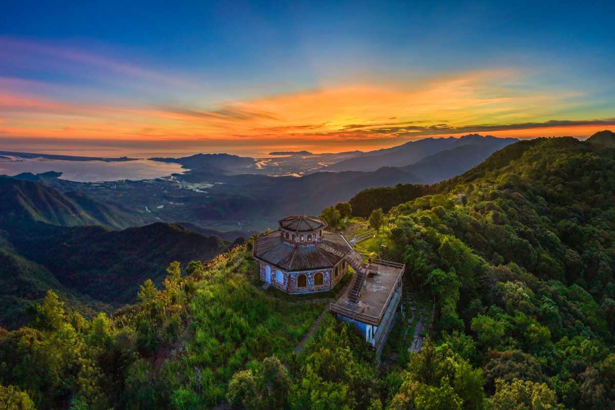 Sunset View from Bach Ma National Park with Mountain Range Scenic sunset with golden light illuminating forested mountains and valleys in Bach Ma Park
