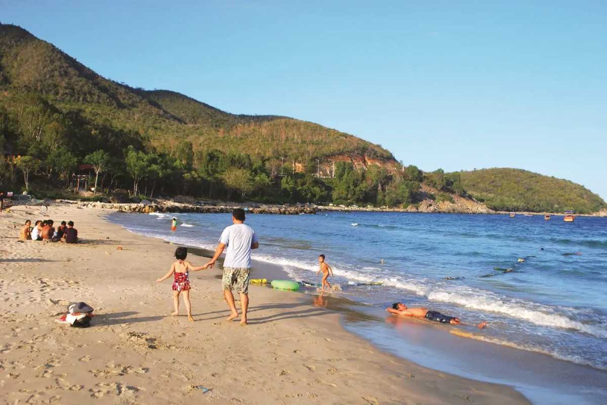 Family Fun at Bai Dai Beach Nha Trang Families enjoying the sunny beach, swimming and playing on the soft sand at Bai Dai Beach Nha Trang.