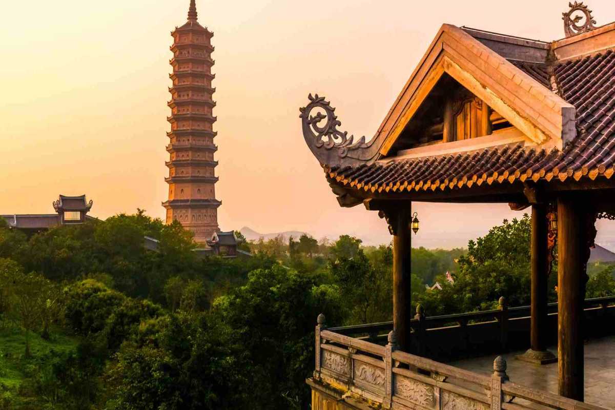 Bai Dinh Pagoda Ninh Binh Bao Thap Tower at sunset Bai Dinh Pagoda Ninh Binh Bao Thap Tower rises above treetops in golden sunset light, highlighting its architectural form