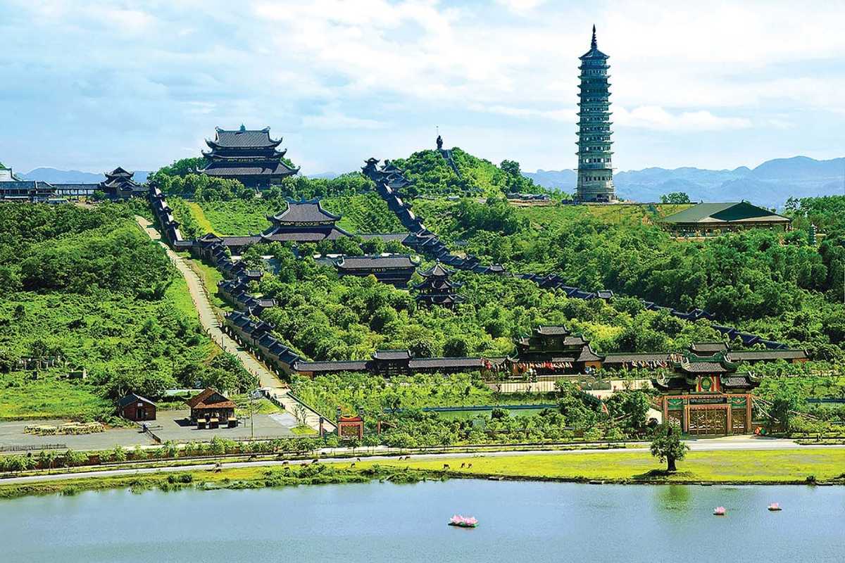 Bai Dinh Pagoda Ninh Binh panoramic temple and Bao Thap Tower view Panoramic view of Bai Dinh Pagoda Ninh Binh complex, showing multiple temples, green hills, and tall Bao Thap Tower