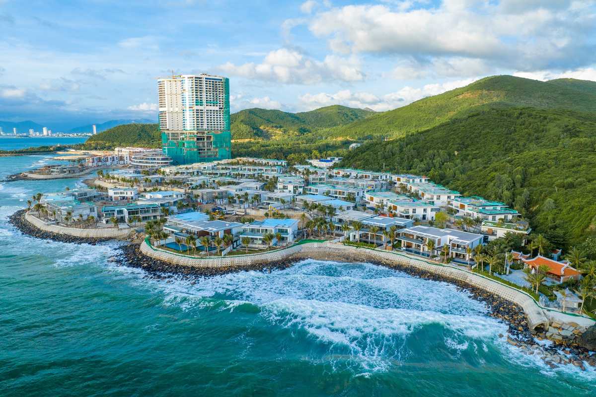 Bai San Beach Nha Trang coastline and resort Coastal view of Bai San Beach with modern resort buildings and lush green hills in Nha Trang