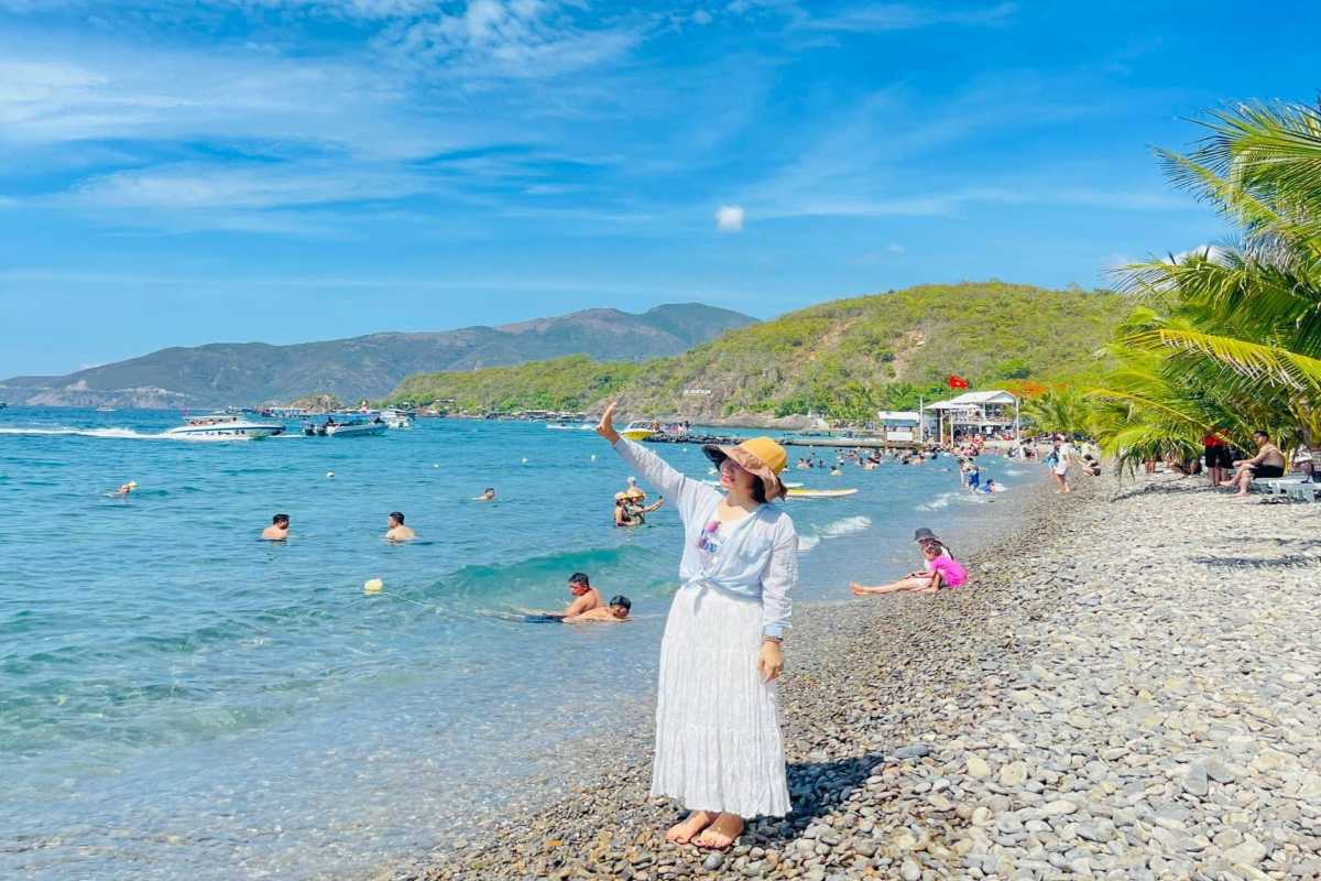 Bai San Beach cove with umbrellas and boats Small cove with sun umbrellas and boats moored at Bai San Beach, Nha Trang