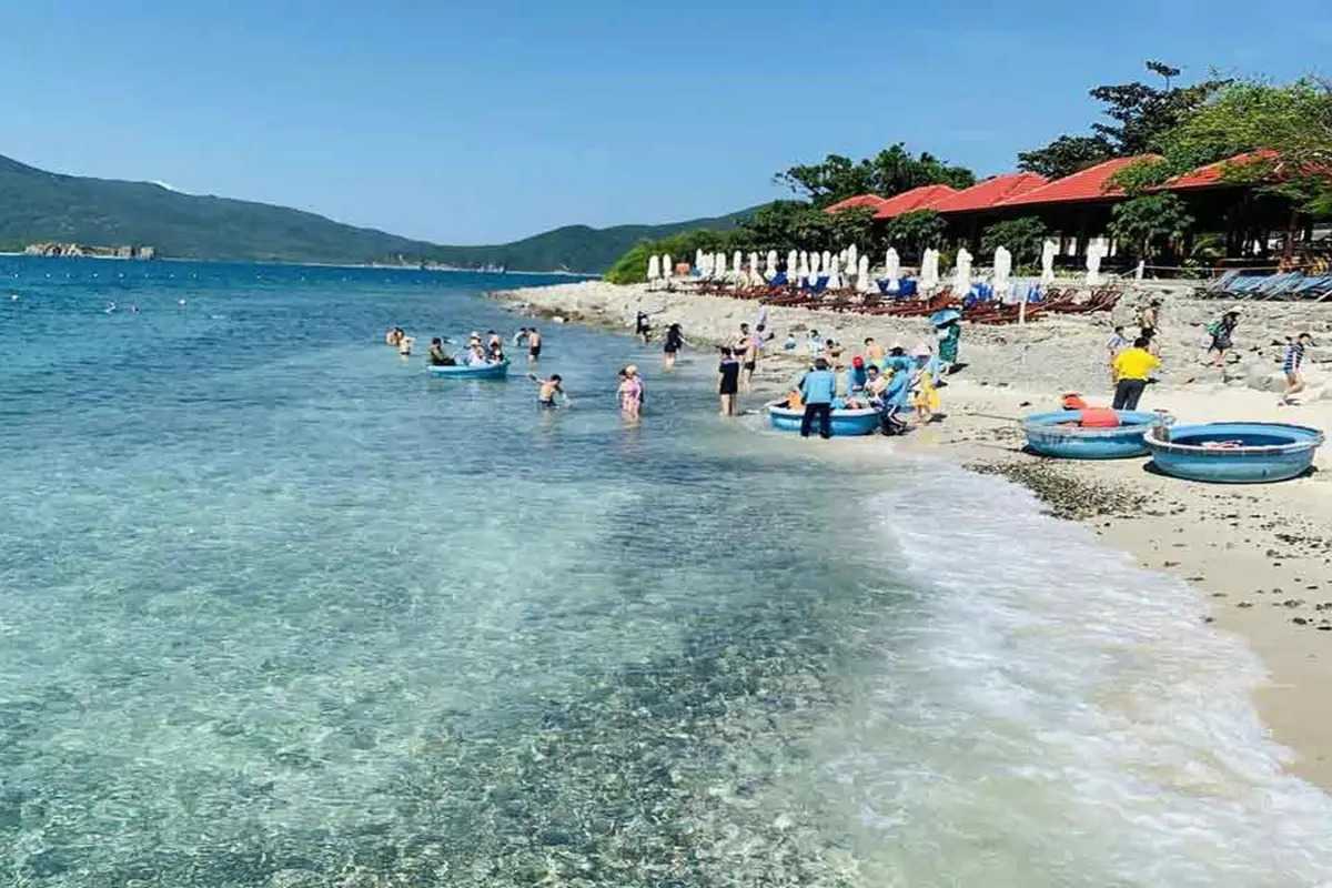 Bai San Beach rocky shore and turquoise waters Rocky shore with turquoise waters and green hills at Bai San Beach, Nha Trang