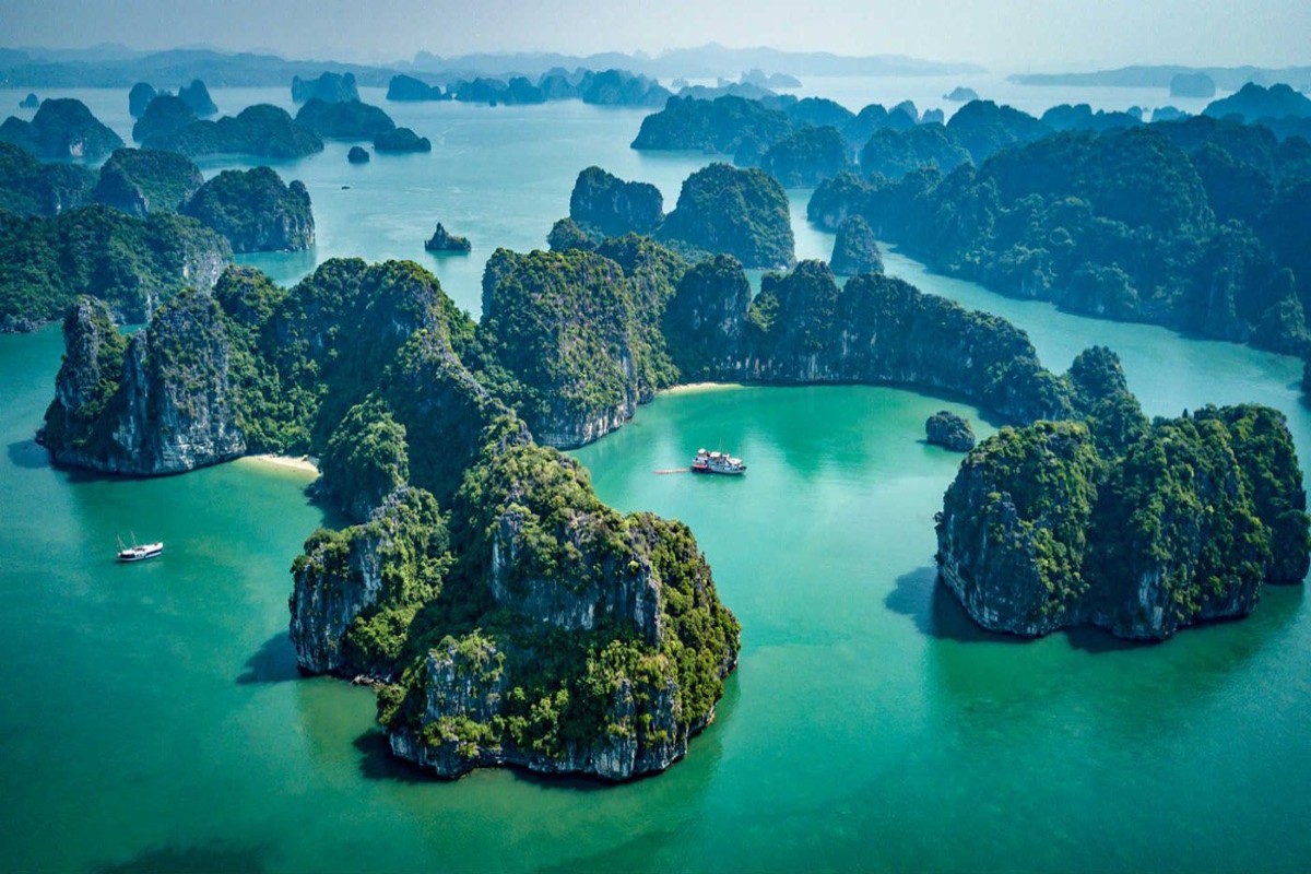 Aerial view of Bai Tu Long Bay with emerald waters and limestone karsts