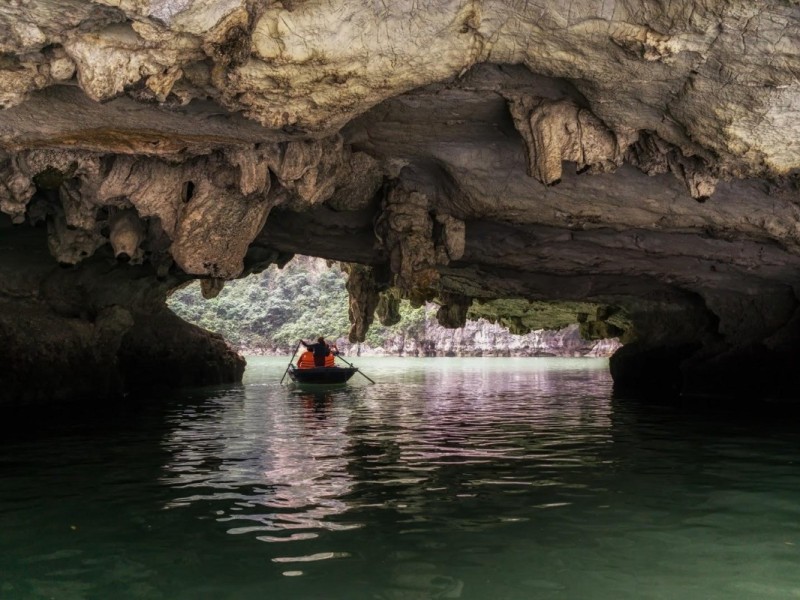 Bamboo boat exploring the hidden lagoon at Trinh Nu Cave, Halong Bay