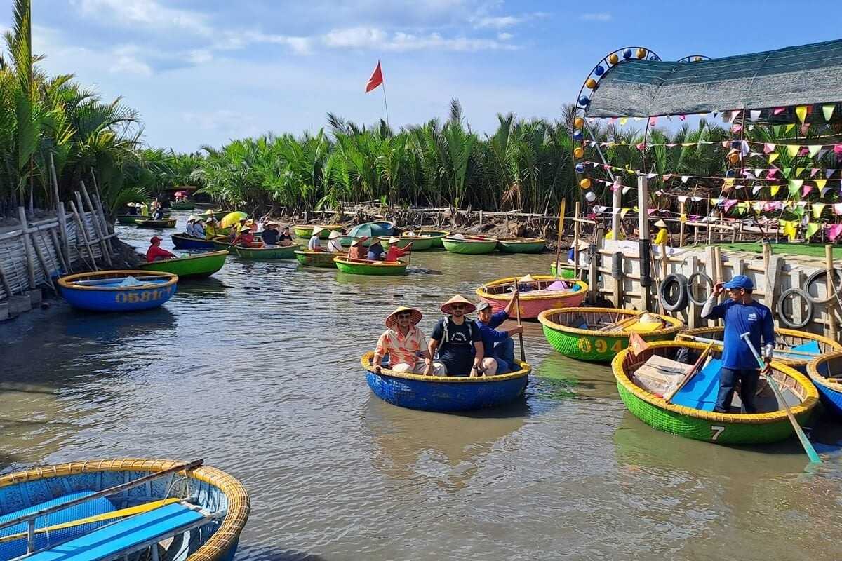 Basket Boats with Tourists at Docking Area Tourists seated in basket boats preparing for tours at the docking area in Cam Thanh Coconut Village