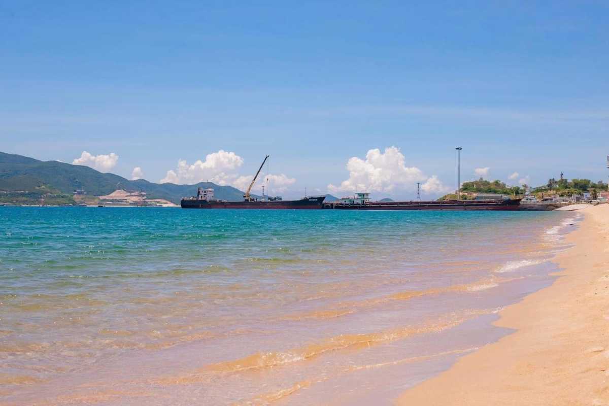 Cau Da Port viewed from beachside Cau Da Port Nha Trang seen from a nearby beach with ships and clear water.
