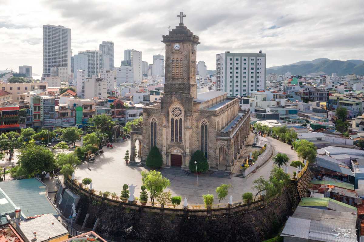 French Colonial Bell Tower of the Church View of the bell tower of Nha Trang Mountain Church with symmetrical Romanesque windows