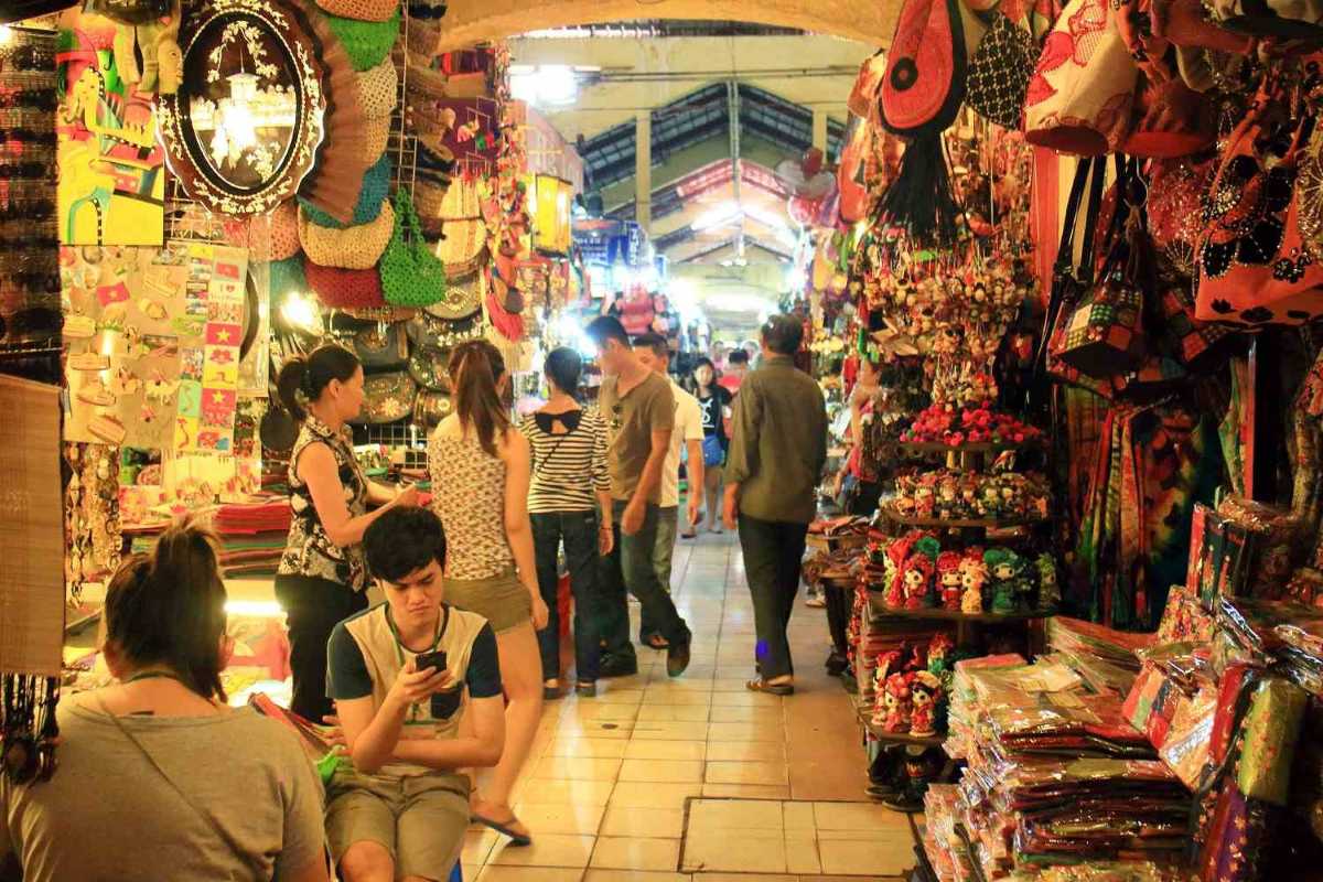 Busy shopping aisles inside Ben Thanh Market Crowded aisles inside Ben Thanh Market with shoppers browsing souvenirs and local crafts