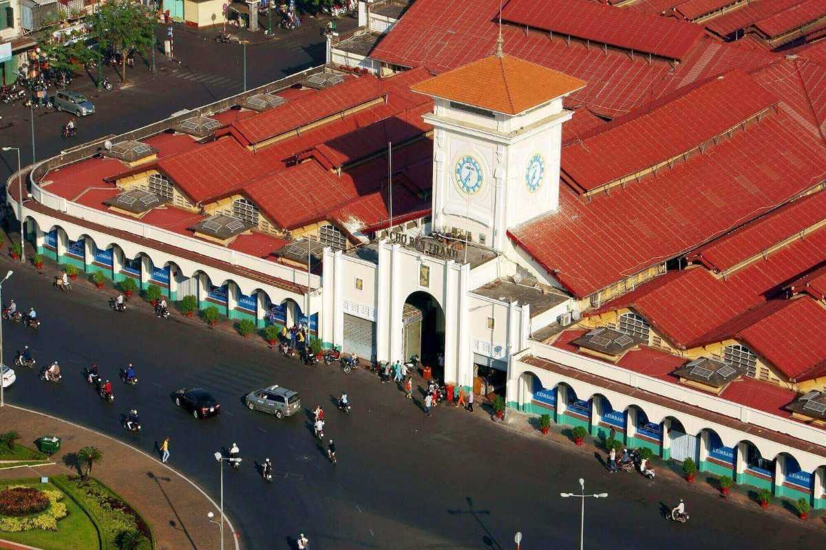 Aerial close-up of Ben Thanh Market clock tower and roof Close-up aerial view of Ben Thanh Market clock tower and red tiled roof from above