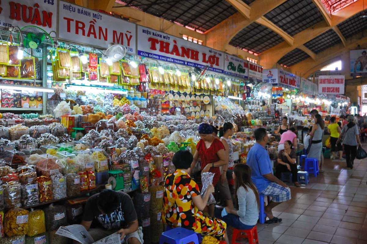 Crowded market scene with shoppers at Ben Thanh Market Vibrant crowd scene inside Ben Thanh Market with shoppers and vendors interacting