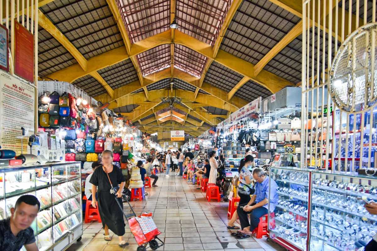 Ben Thanh Market indoor shopping aisles with vendors Indoor view of Ben Thanh Market showing busy shopping aisles with vendors and colorful merchandise
