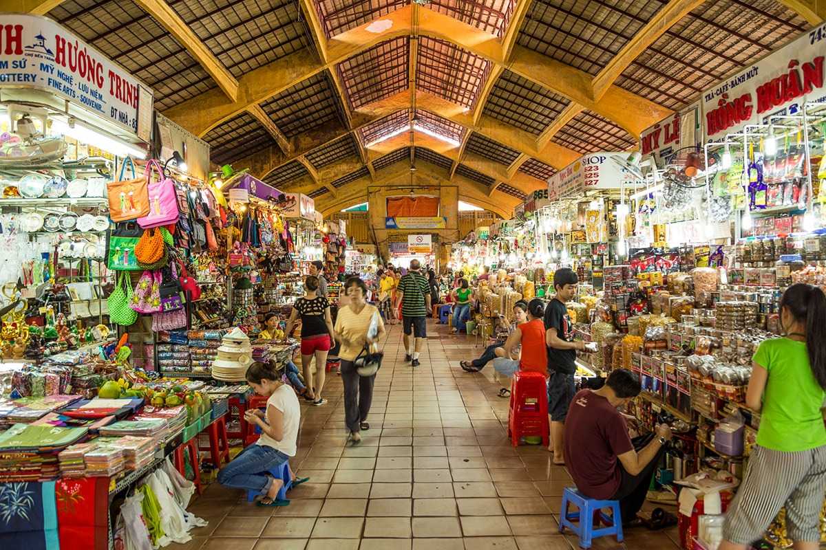 Ben Thanh Market souvenir and gift stall colorful display Colorful souvenir and gift stall inside Ben Thanh Market showcasing bags and traditional crafts