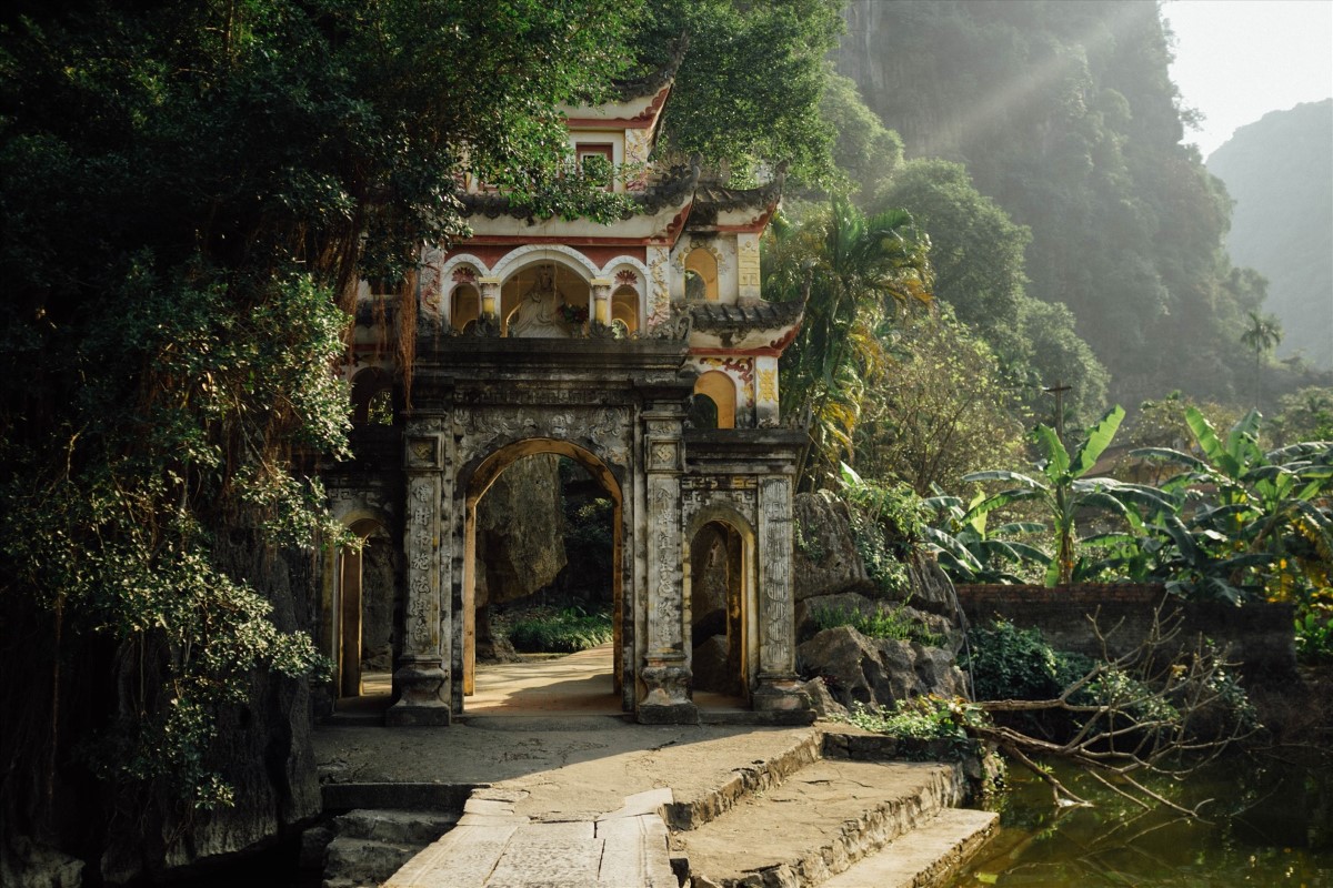 Bich Dong Pagoda surrounded by lush greenery in Ninh Binh, showcasing ancient Vietnamese architecture.